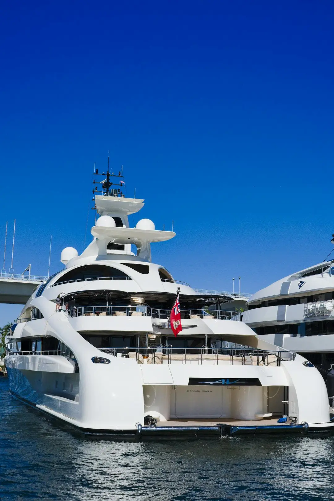 Stern of a superyacht with the beach club and tender garage open at the waterline